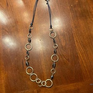 Chico’s extra long 36” muted gold tone and black necklace.